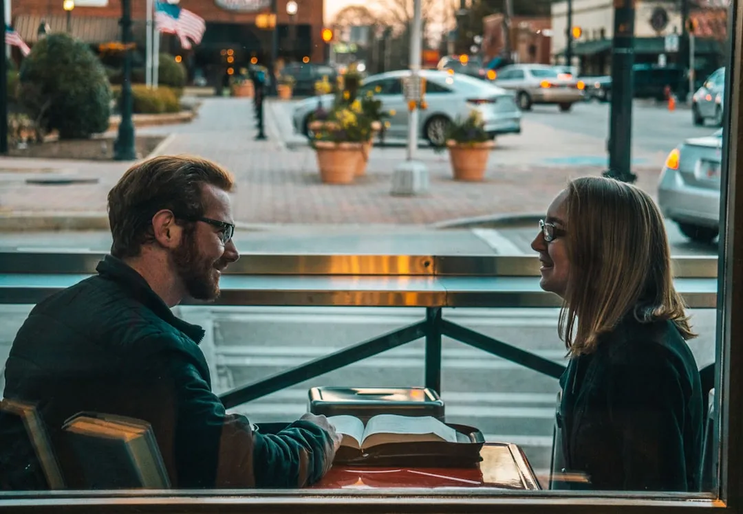 A man and woman sitting together having a warm, focused conversation
